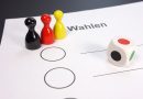 Brettspielfiguren und ein Würfel auf einem Wahlzettel